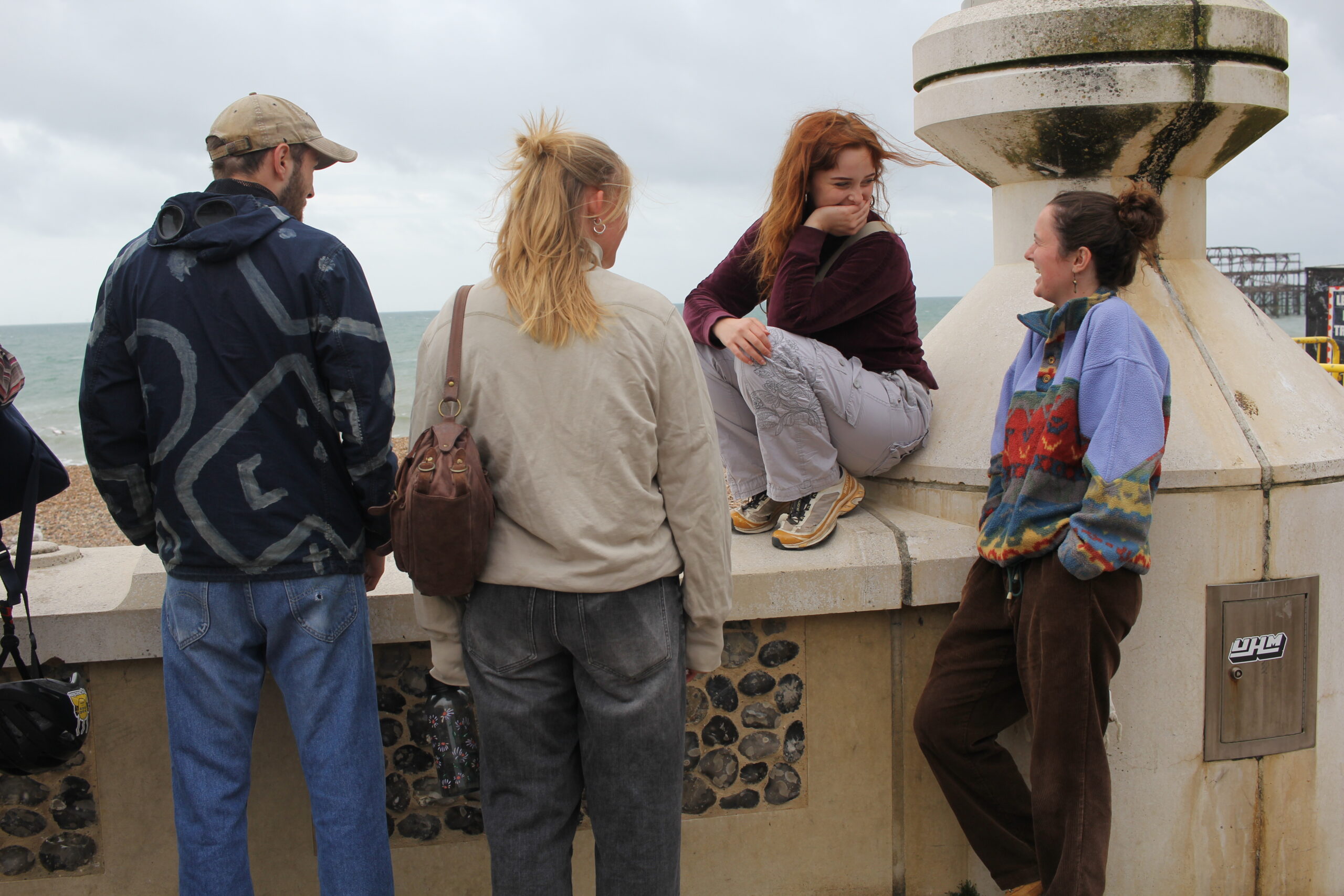 Young people laughing together on Brighton beach