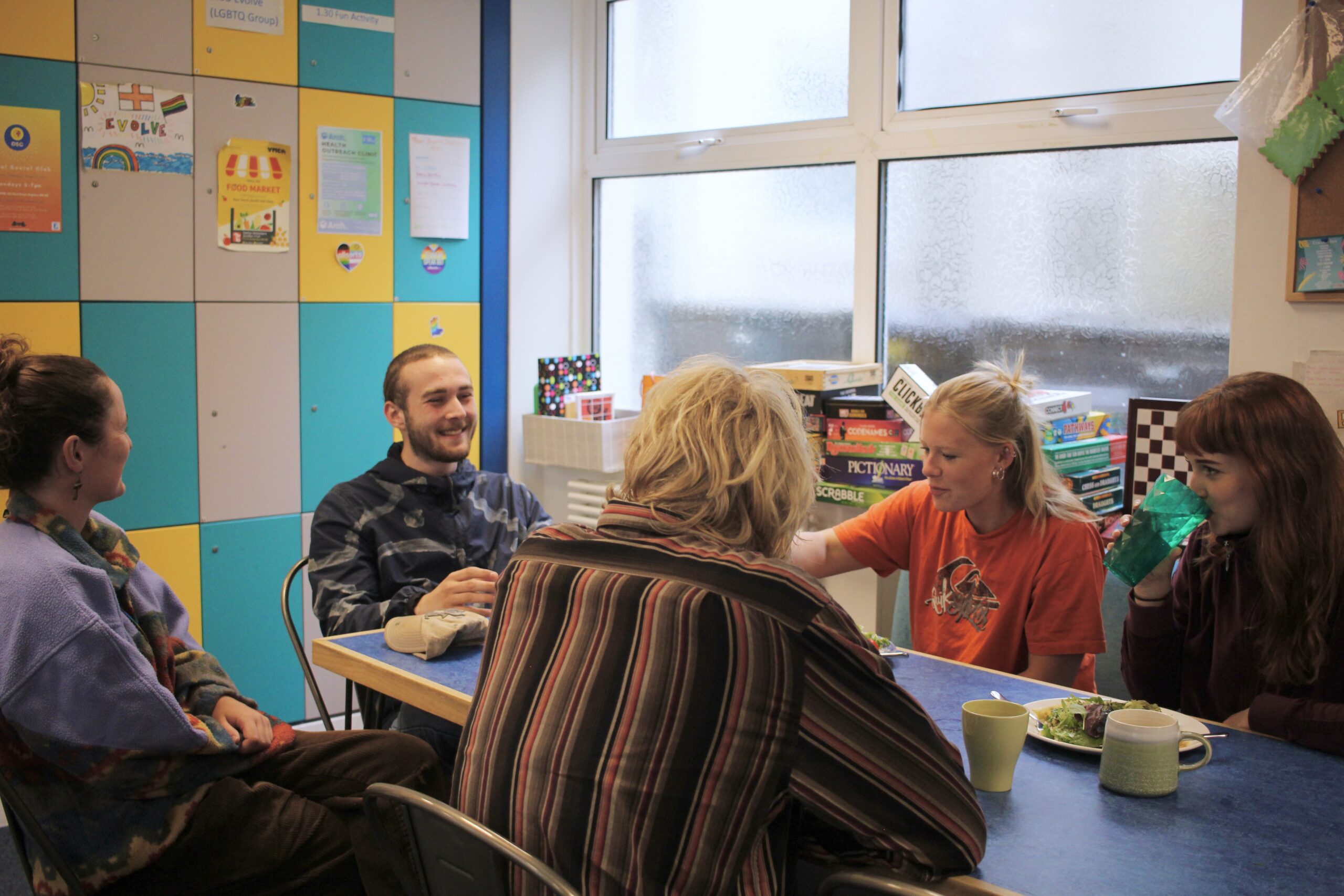 Young people eating and laughing together in our day centre