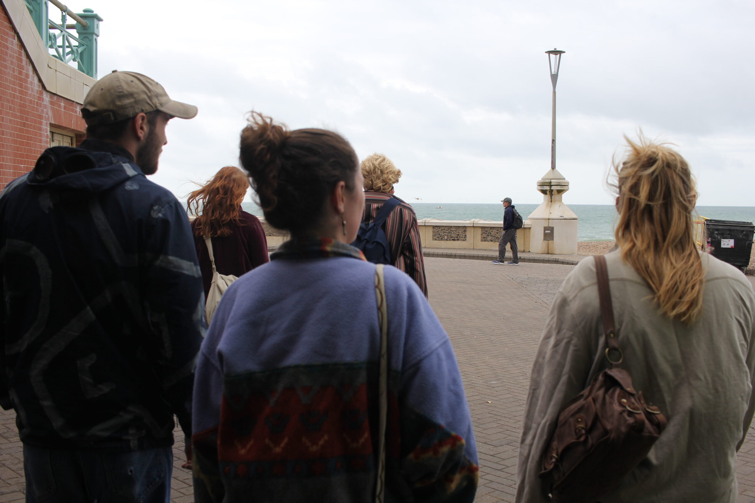 Young people walking along the Brighton seafront